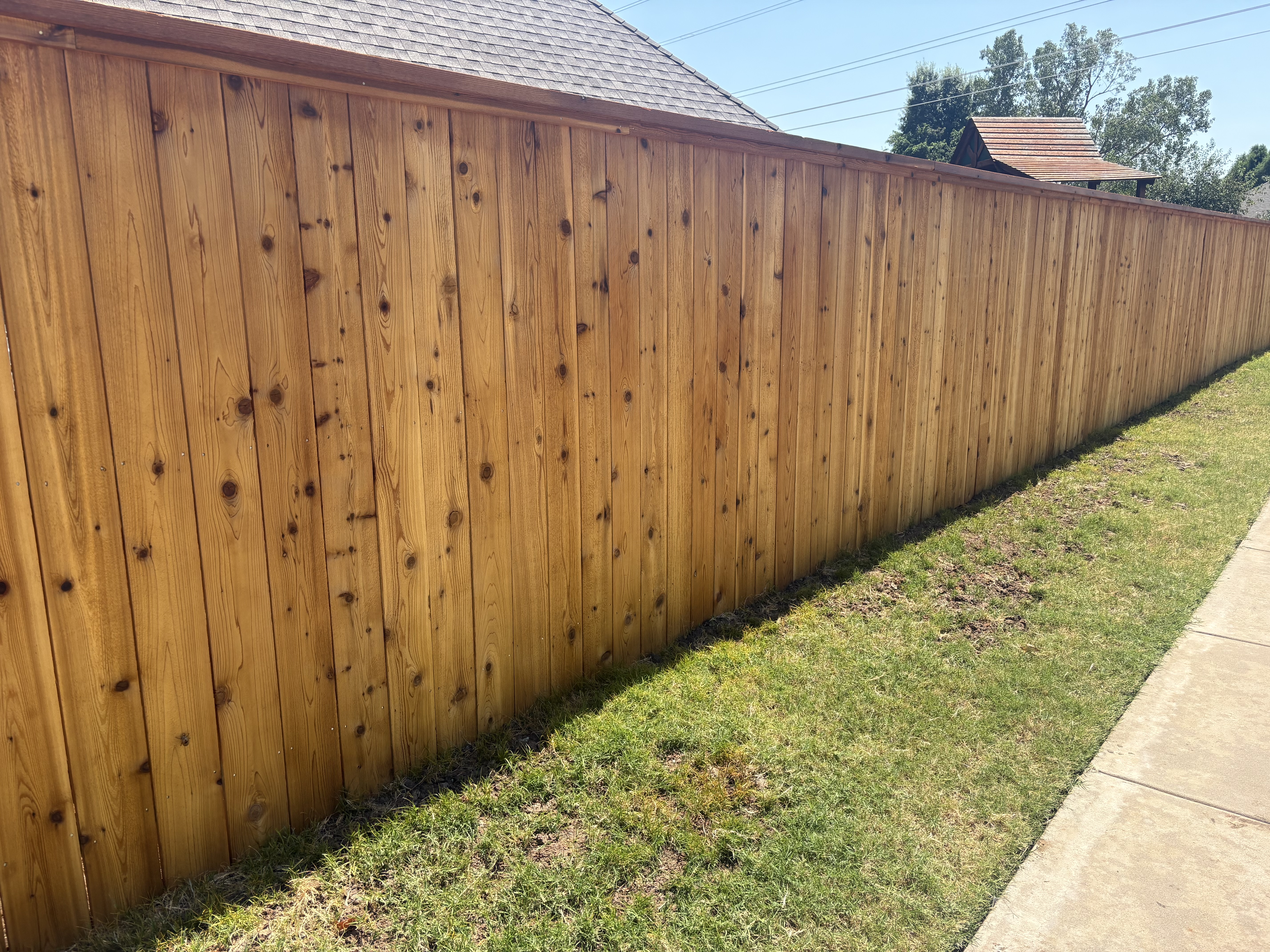 Fence company Oklahoma crew installing a cedar privacy fence at a home in the Oklahoma City metro